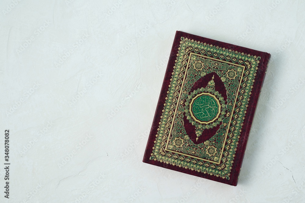 Holy Quran with written arabic calligraphy meaning of Al Quran on white background. Holy Quran with written arabic calligraphy meaning of Al Quran on white background.