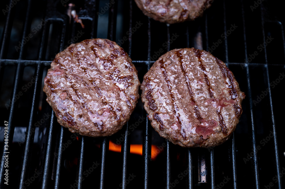 burgers on the bbq grill with potato wedges in pan and giant mushrooms burgers on the bbq grill with potato wedges in pan and giant mushrooms