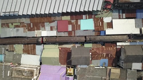 Maeklong Railway in Samut Songkram, Thailand - Traveling through market - Aerial zoom photo