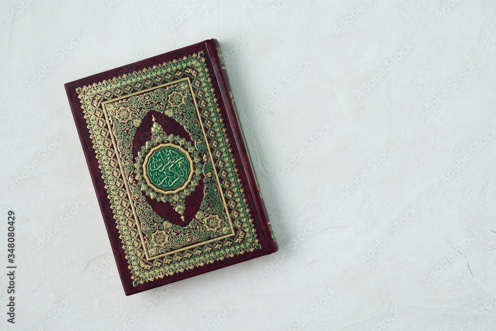 Holy Quran with written arabic calligraphy meaning of Al Quran on white background. Holy Quran with written arabic calligraphy meaning of Al Quran on white background.