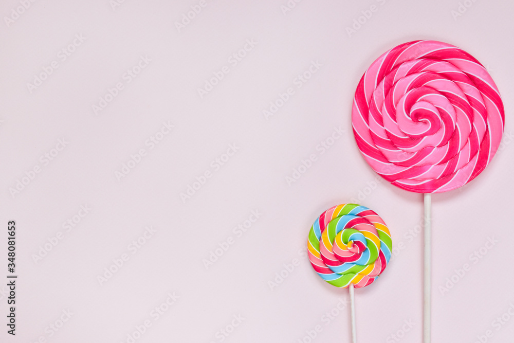 Two bright round multi-colored candies of different sizes. Two bright round multi-colored candies of different sizes.