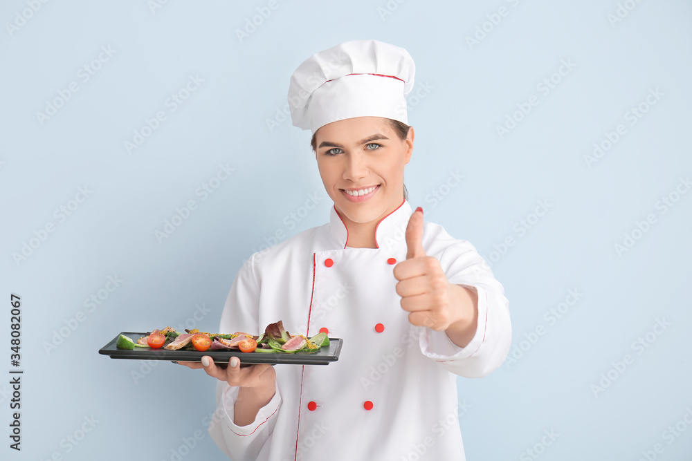 Transgender chef with salad on color background Transgender chef with salad on color background