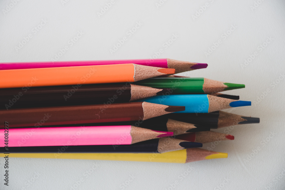 Naklejka premium colored pencils on white background