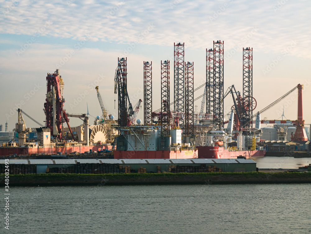Rotterdam, Netherlands - May 08, 2020: evening view on the cargo port buildings infrastructure from the cruise ship Rotterdam, Netherlands - May 08, 2020: evening view on the cargo port buildings infrastructure from the cruise ship