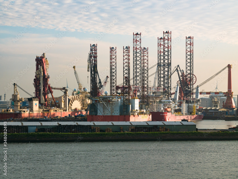 Rotterdam, Netherlands - May 08, 2020: evening view on the cargo port buildings infrastructure from the cruise ship