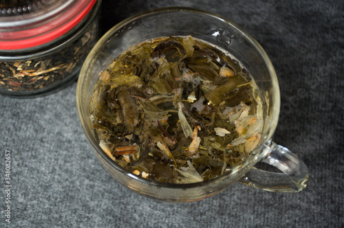 glassy cup with green leaf tea 