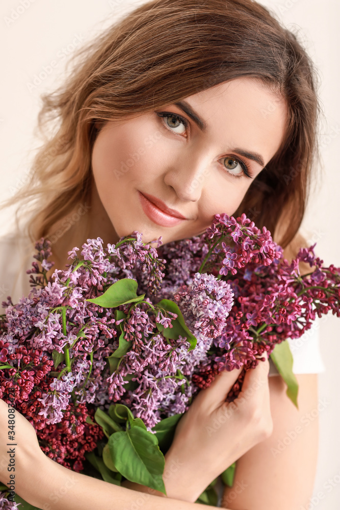 Beautiful young woman with bouquet of lilac flowers on white background Beautiful young woman with bouquet of lilac flowers on white background