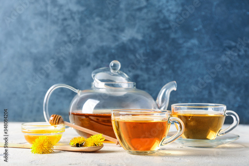 Healthy dandelion tea with honey on table