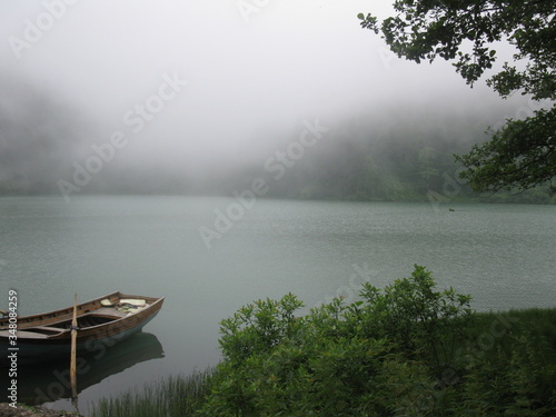 Obraz na plátně Rowboat Moored On Lake In Foggy Weather