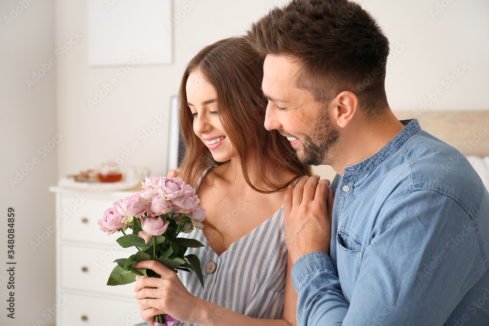 Young woman with received bouquet of flowers from her boyfriend at home Young woman with received bouquet of flowers from her boyfriend at home