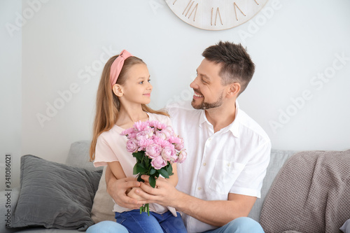 Little daughter giving bouq...