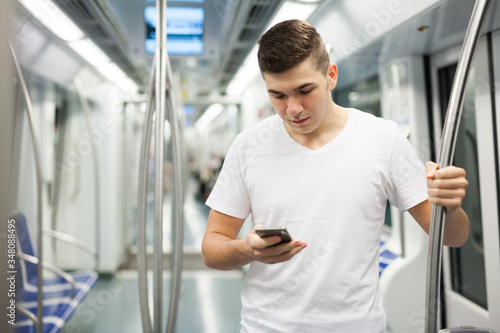 Passenger reading phone in subway