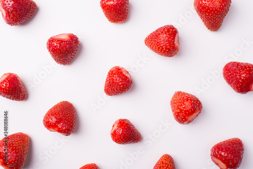 Top above overhead view photo of peeled strawberries on isolated white background
