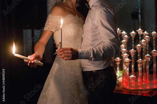 bride and groom light candles at a wedding