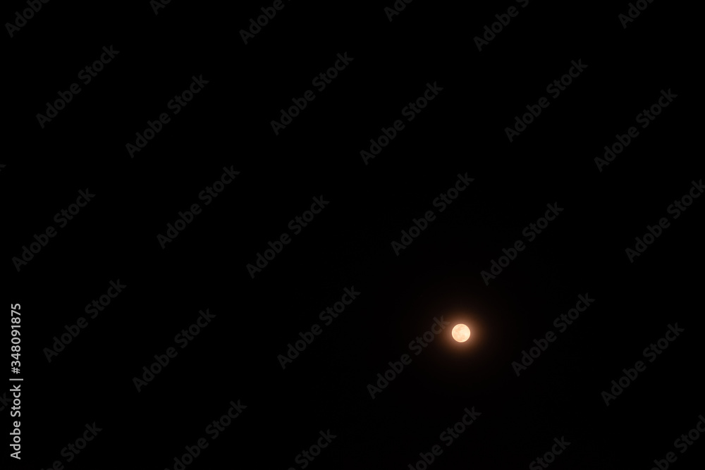 Full moon over the black sky at night. Full moon over the black sky at night.