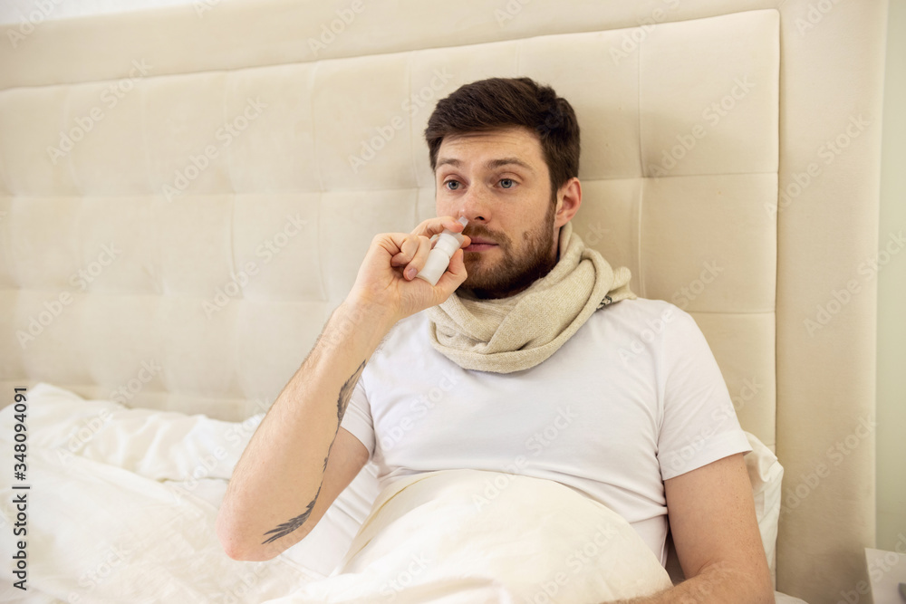 Sick Man Using Nasal Spray. Ill Man at Home Using Nose Spray Sick Man Using Nasal Spray. Ill Man at Home Using Nose Spray