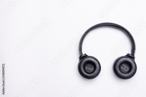 Black headphones on the right side of the photo. From above . White background. Copy space