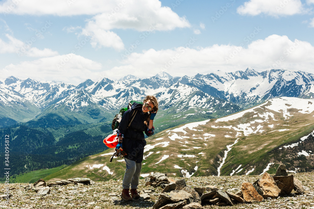 Woman traveler hiking in mountains with backpack adventure travel healthy lifestyle active summer vacations explore. Cheerful positive hipster girl. Lifestyle concept sport outdoor.