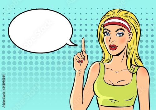 Woman in sport clothes is pointing index finger up. Pop art vector comic illustration.