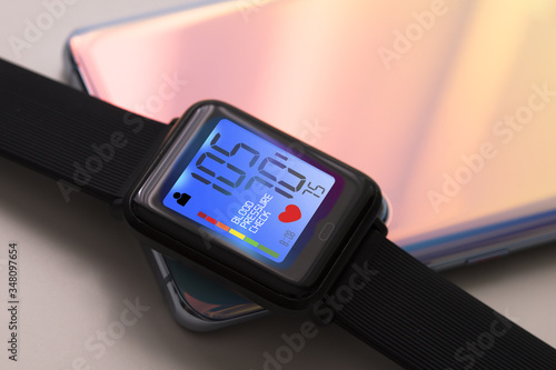 Measure blood pressure level with smartwatch and mobile phone tracking modern solutions for heart rate and pulse