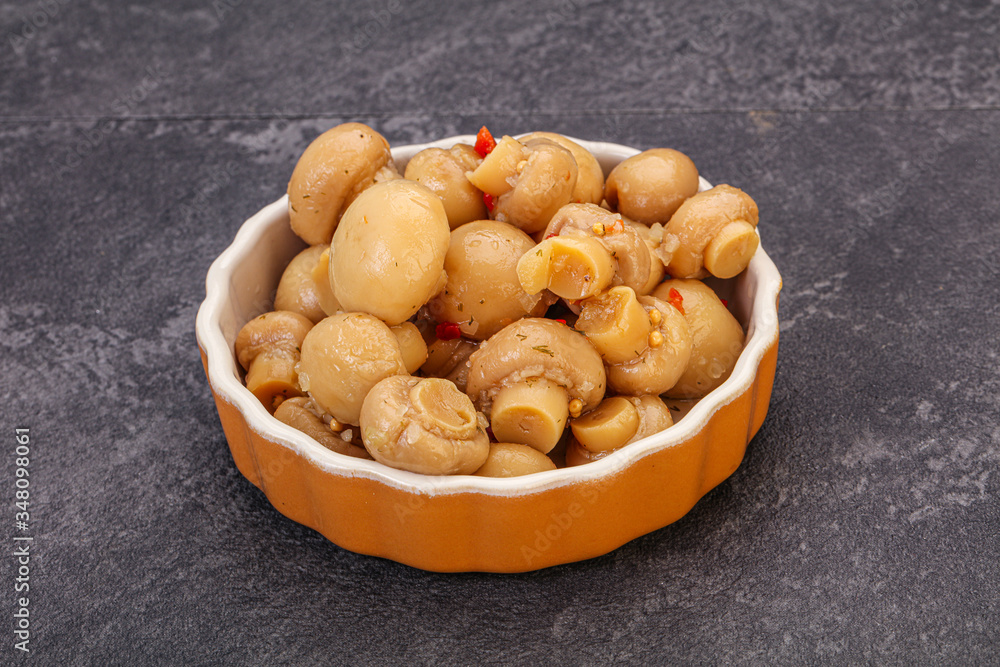Pickled champignons in the bowl Pickled champignons in the bowl