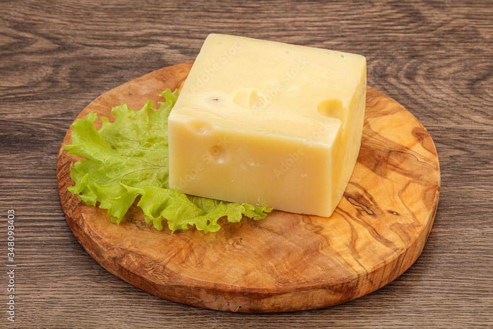 Emmental cheese over wooden board