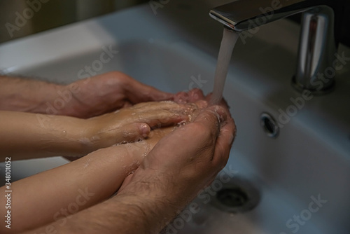 washing hands with soap. Washing a child’s hands with soap and water to prevent coronavirus and hygiene to stop the spread of coronavirus. wash your hands with soap and hot water