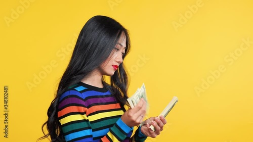 Pretty asian woman counting money