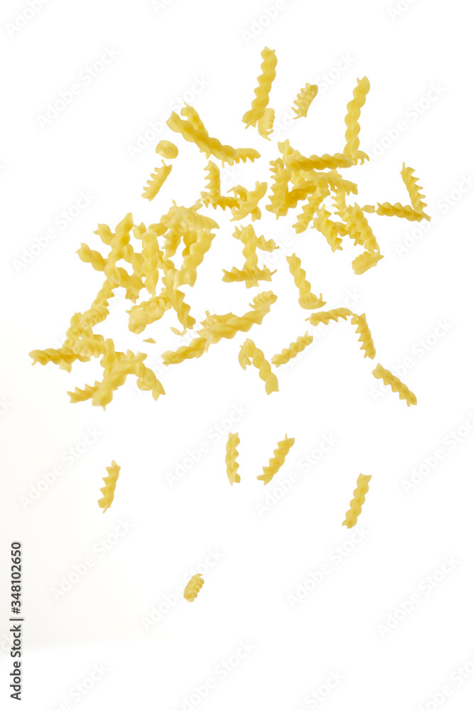 Italian flying raw pasta isolated on white background. macaroni fusilli falling.
