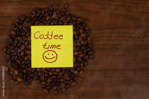 White coffee cup and coffee beans on a wooden table.Coffee time