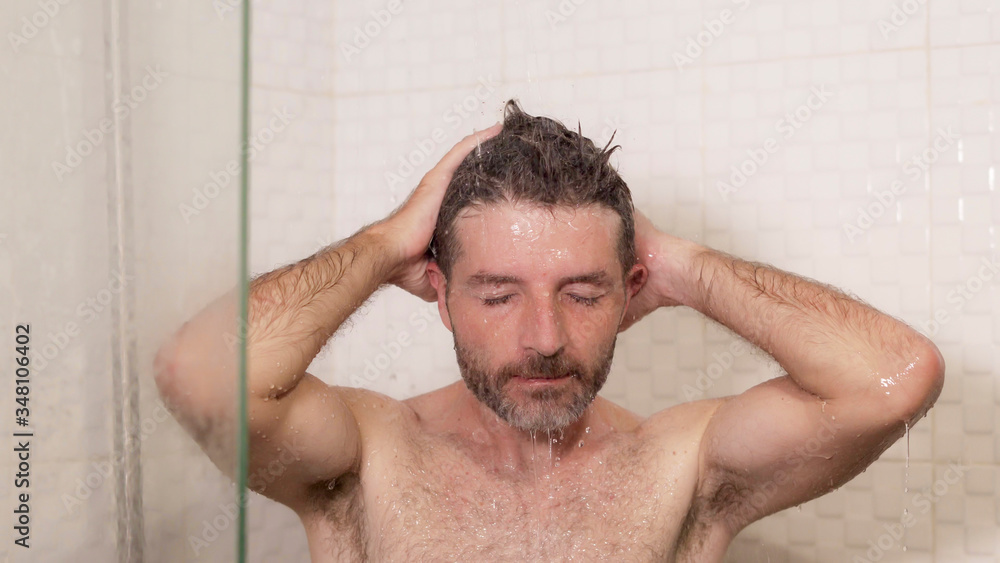 young attractive and happy man with beard taking a shower at home washing his hair with shampoo cheerful enjoying the morning shower in wellness and hygiene concept young attractive and happy man with beard taking a shower at home washing his hair with shampoo cheerful enjoying the morning shower in wellness and hygiene concept