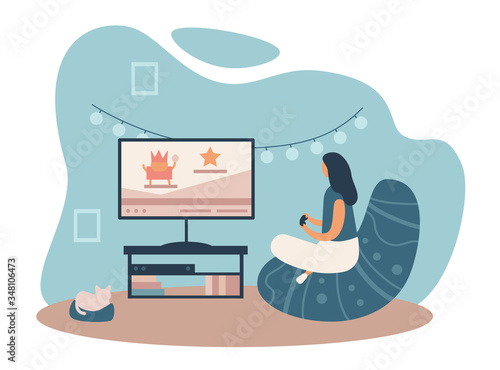 Woman playing video game while spending time at home