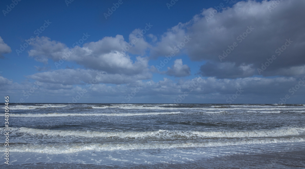 Northsea coast Netherlands. Julianadorp. Beach. Breaking waves. Clouds Northsea coast Netherlands. Julianadorp. Beach. Breaking waves. Clouds