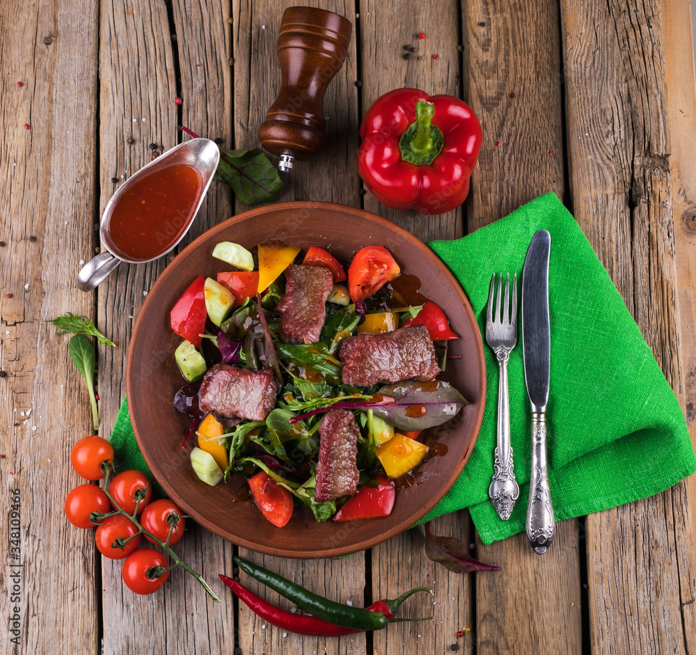 Veal salad with vegetables. Salad on a white plate. Veal salad with vegetables. Salad on a white plate.