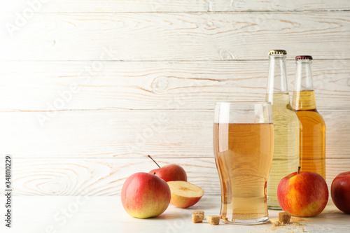 Composition with cider, sugar and apples on white wooden background