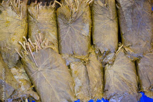 Pickled grape leaves close-up. Grape leaves for preparation of traditional oriental dishes and snacks on counter of oriental bazaar photo