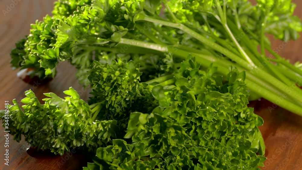 Green salad. Parsley on a cutting board close-up. Vegetarian food. Green salad. Parsley on a cutting board close-up. Vegetarian food.