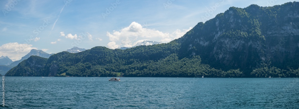 panoramic view into the mountains on a boat cruise on lake lucerne