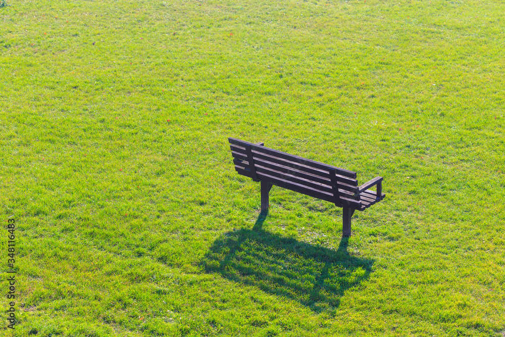 Wooden bench in green grass field. Wooden bench in green grass field.