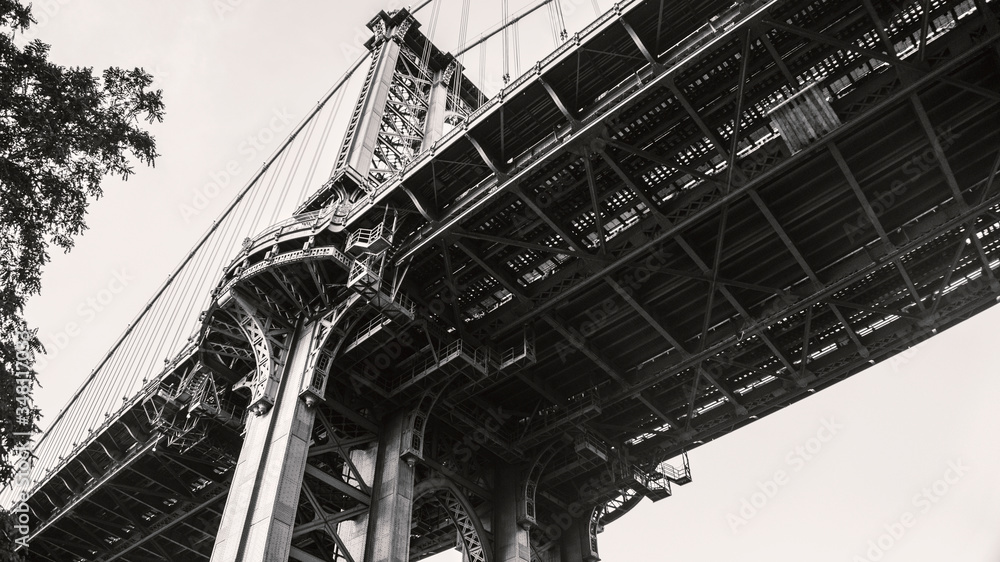 Underside view of the Manhattan Bridge in New York in black and white.