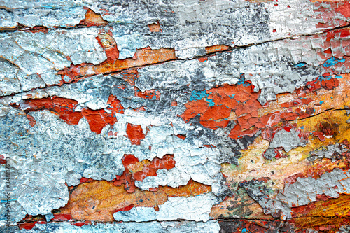 Colorful cracking and pealing paint. Grunge background image. photo