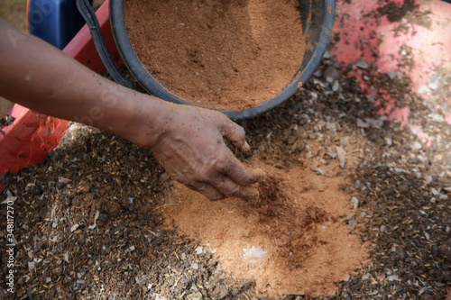 Preparation of soil mixture from fertile compost, humus and vermiculite  in the garden. Springtime gardening work. 