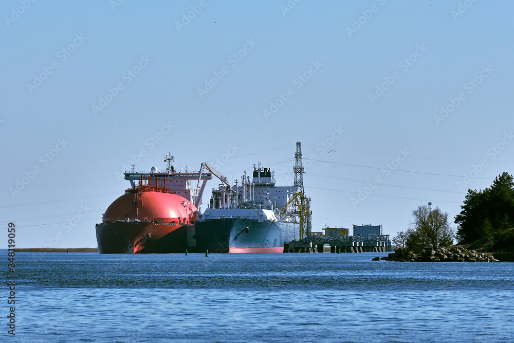 LNG tanker and carrier as floating LNG storage and import terminal in port. Alternative gas supply, commercial freight, energy crisis, diversification