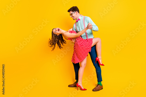 Full length profile photo attractive lady handsome guy prom party couple hugging dancing raise leg close wear red dotted dress shirt bowtie retro clothes isolated yellow color background