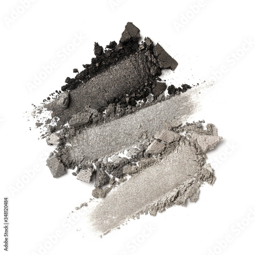 Close-up of make-up swatches. Smears of crushed shiny gray eye shadow