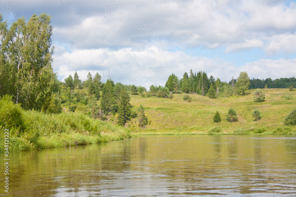Summer landscape of the Chusovaya river with green hills in the background. Russia, the Urals Summer landscape of the Chusovaya river with green hills in the background. Russia, the Urals