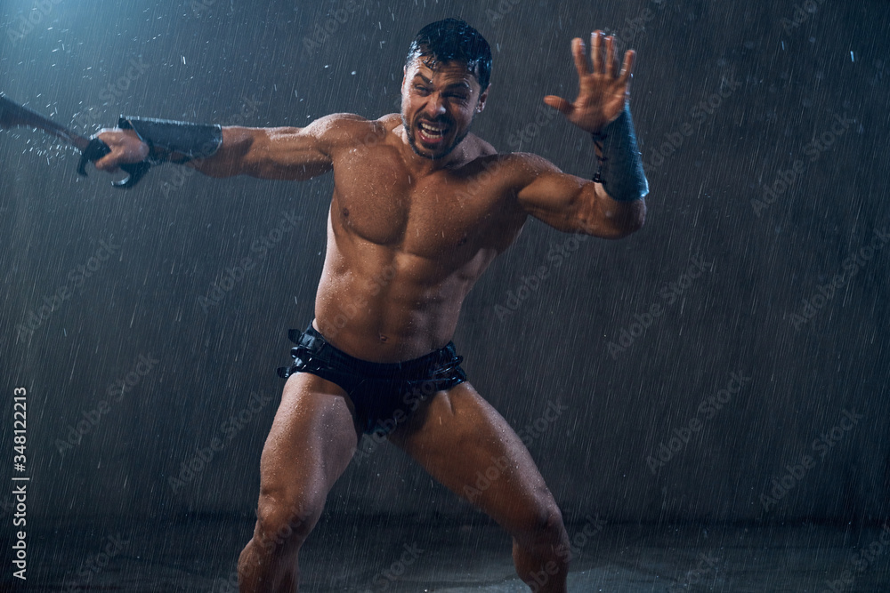 Obraz premium Muscular warrior attacking with sword.