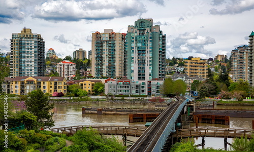 
Railway over Fraser river on the waterfront in Downtown of New Westminster Fraser River, green trees at the promenade on a background of cloudy sky
 photo