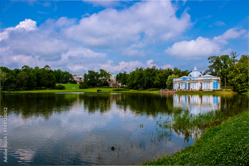 Russia. St. Petersburg. Tsarskoye Selo. Palace Catherine Park. Summer landscape. The lake among the park. Trees and buildings are reflected in the water.