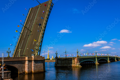 Russia. St. Petersburg. The bridge across the Neva.
  In the open section of the bridge, the spire of the Peter and Paul Cathedral is visible.